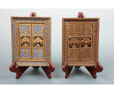 A pair of small carved shuttered picture frames, one parcel-gilt and painted, each containing a monochrome photogravure print