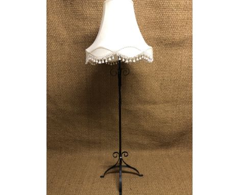 A wrought iron standard lamp