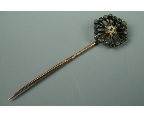 An antique yellow-metal stick pin, set with green and white stones, tested as gold, 3.2g (a/f)