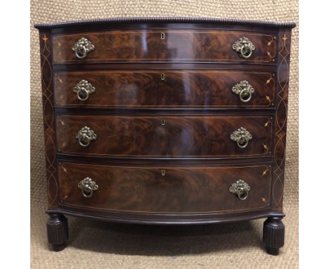 A fine early Victorian inlaid-mahogany chest of drawers, having brass ring handles, turned mouldings and reeded legs