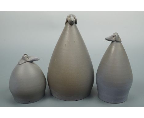 Three contemporary ceramic dog figurines, bearing impressed puffin marks, tallest 18 cm