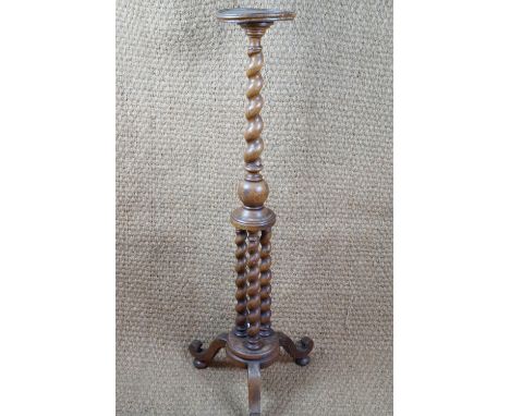 A turned oak torchere bearing an engraved brass plaque with inscription "Constructed of old oak from St Paul's Cathedral", co