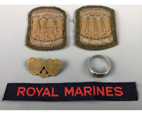A Royal Artillery Mizpah type sweetheart brooch, a trench art finger ring, two drummers' qualification badges and a Royal Mar