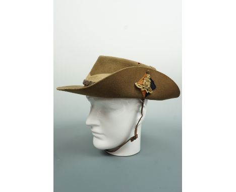 A Second World War British army bush / slouch hat, bearing a Royal artillery badge and backing, the liner inscribed "Gnr Sher