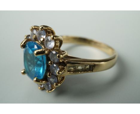 A contemporary Swiss blue topaz, tanzanite and yellow beryl dress ring, in a flower head cluster setting, on 9ct gold, size R