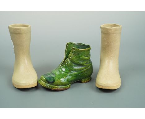 A pair of ceramic boots, 14 cm high, and one other