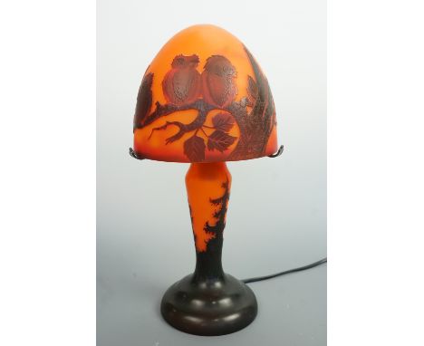 A reproduction Galle glass table lamp, of organic form, the shade decorated with owls perched on a tree branch, base bearing 