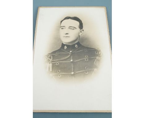 A framed pre Great War photograph of a British soldier wearing a Broderick cap, a framed 1918 army commission award document 