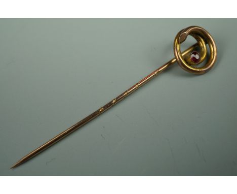 A late 19th / early 20th Century yellow metal stick pin with coiled terminal set with a pink stone, 5 cm, .9 g