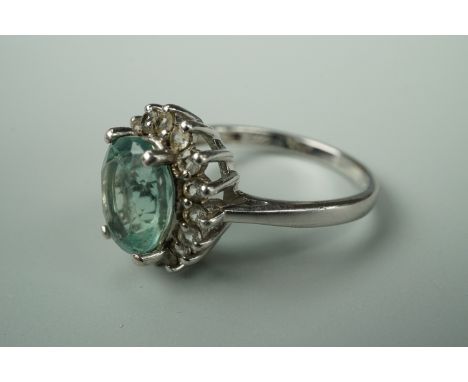 A contemporary green stone dress ring, in a flower head cluster setting, stamped 935 and tested as silver, size H, 3.8g