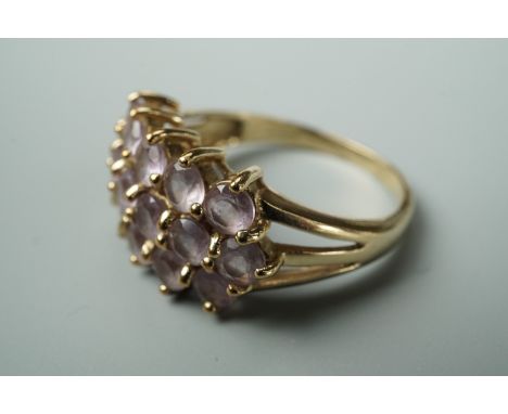 A contemporary Rose de France amethyst dress ring, having three rows of sixteen claw set amethysts, each 3.5 mm, on 9ct gold,