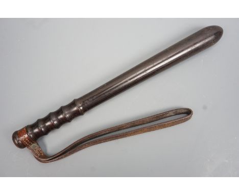 A British military police truncheon, in turned ebony or a similar hardwood with leather wrist strap, bearing and Ordnance bro