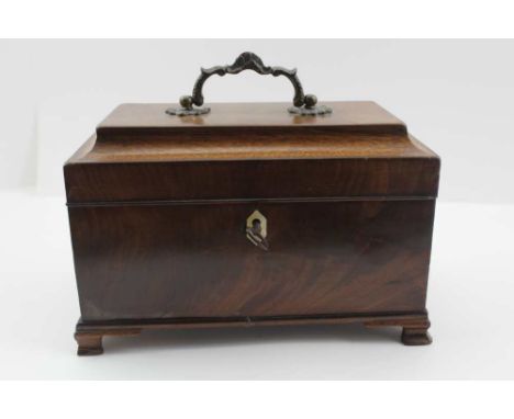 A 19TH CENTURY MAHOGANY TEA CADDY, having hinged lid with decorative brass handle, opening to reveal two internal lidded comp