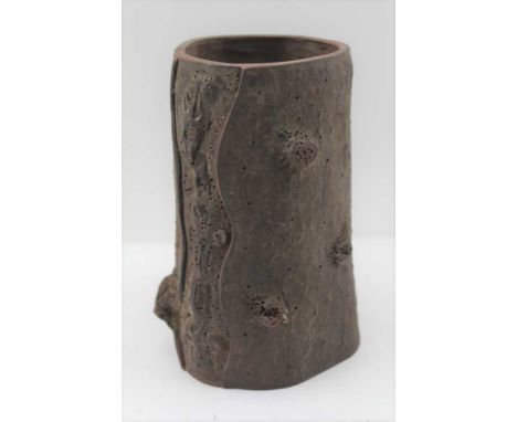 AN ORIENTAL RED CLAY BRUSH POT of moulded tree trunk design, impressed seal and "CWS" mark to base, 16.5cm high 