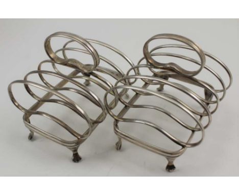 ASPREY &amp; CO. LTD A PAIR OF SILVER TOAST RACKS, squat form, raised on trefid feet, Sheffield 1927 and 1928, combined weigh