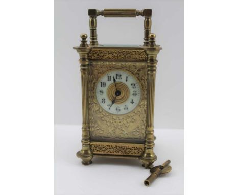 A FRENCH BRASS CASED CARRIAGE CLOCK, c.1900, bevelled glass and pierced decorative panels, including winged mythical creature