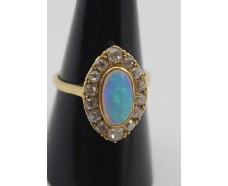 A MARQUISE SHAPED OPAL &amp; DIAMOND RING, the central fiery opal surrounded by fourteen bright cut diamonds, considered to b