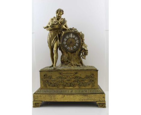 A 19TH CENTURY FRENCH ORMOLU MANTEL CLOCK, cast case with Bacchus cradling an infant whilst leaning against a tree trunk, on 