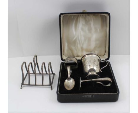 WILLIAM HAIR HASELER A SILVER CHRISTENING SET, comprising; mug, napkin ring, spoon and pusher, Birmingham, mixed years, the m