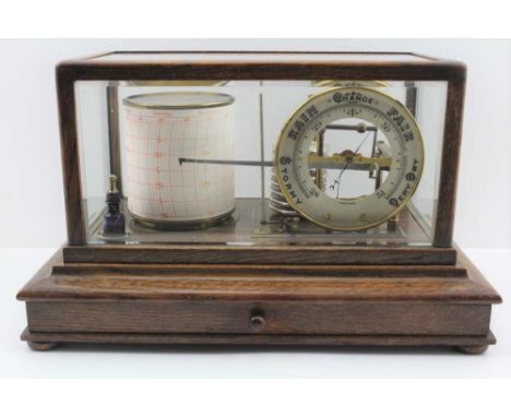 AN EARLY 20TH CENTURY "TYCOS" OAK CASED BAROGRAPH, with barometer dial, set bevel edge glass, the base fitted drawer for prin