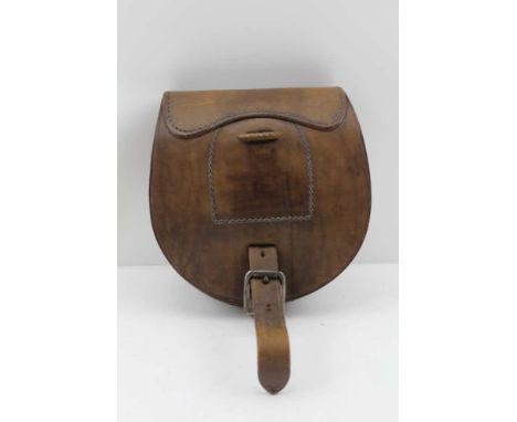 A SECOND WORLD WAR FARRIER'S LEATHER POUCH CONTAINING A HORSE SHOE, stamped "D.M. &amp; S. Ltd", dated 1944, bears the War De