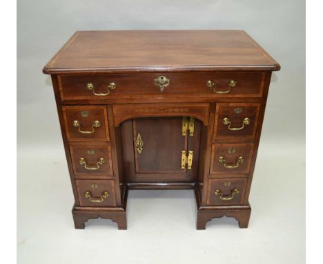 A LATE 19TH CENTURY GEORGIAN DESIGN KNEE-HOLE DESK, with satinwood crossbanded top, over single full width drawer, the knee-h