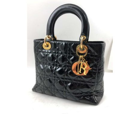 A CHRISTIAN DIOR "LADY DIOR" QUILTED BLACK PATENT HANDBAG, cannage top stitching, gilt brass fittings, red lining, 26cm wide,