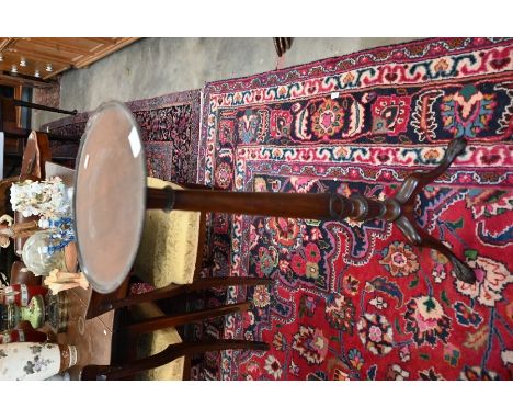 A carved mahogany torchere/plant stand on tripod base with claw and ball feet