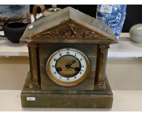 A Victorian oil lamp with cranberry glass font and cast iron base to/w an onyx mantle clock with drum movement (2)