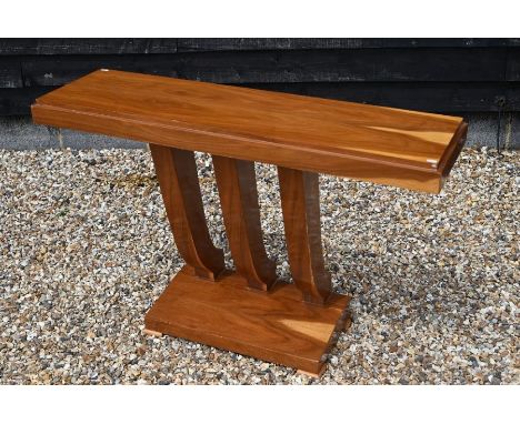 An Art Deco style satinwood console table on three swept pillars and sloping platform base, 78 cm high x 121 cm wide x 35 cm 