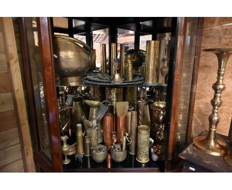 A collection of various antique metalware including Middle Eastern circular trays, brass scuttle, copper and brass shell case