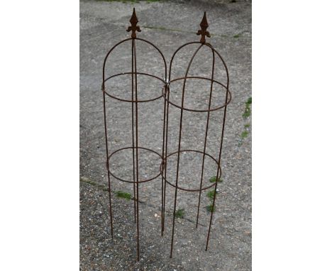 A pair of small weathered steel arrow head obelisks, 121 x 28 cm (2)