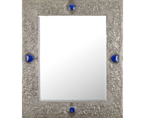  SCOTTISH ARTS & CRAFTS WALL MIRROR, CIRCA 1910 repoussé-decorated tin, set with glazed ceramic panels, bevelled mirror plate
