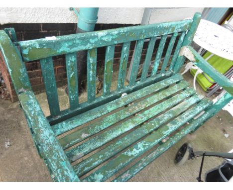 A WOODEN PARK BENCH PAINTED GREEN. (AF)