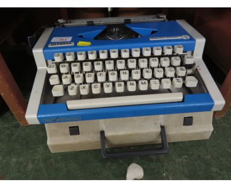 OLYMPIA TRAVEL DELUXE TYPEWRITER IN A PLASTIC CARRY CASE.