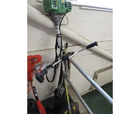 A FLORA BEST PETROL GARDEN MULTI TOOL WITH STRIMMER HEAD , CHAIN SAW HEAD , HEDGE TRIMMER HEAD AND OTHER ATTACHMENTS.