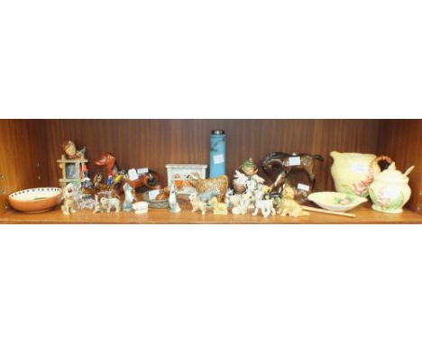Two Hummel figures, 'Playmates' and 'Signs of Spring', two Beswick figures, 'Foal (lying)' and 'Foal (large, head down)', bot