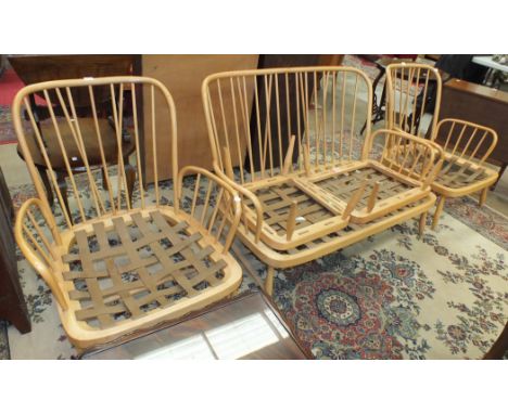 A vintage Ercol light wood stick-back lounge suite, comprising a two-seater settee, two armchairs and two stools, (5).