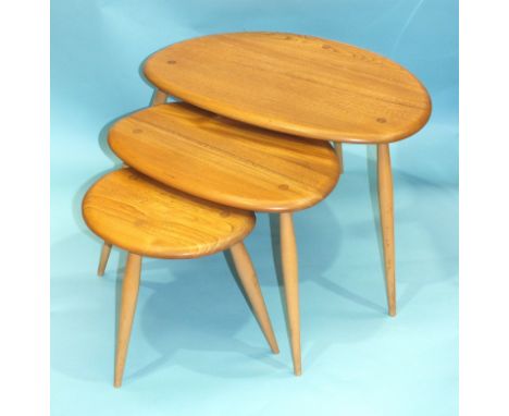 An Ercol nest of three light elm and beech 'Pebble' tables, largest 64cm wide, 41cm high.