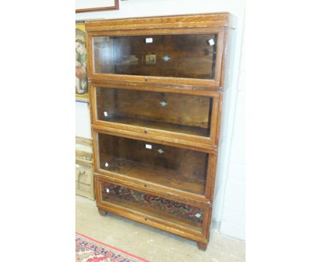 A Globe Wernicke oak finish four-section bookcase, 85cm wide, 142cm high.