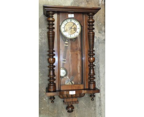 A late-19th/early-20th century stained wood Vienna-style striking wall clock, 74cm high.