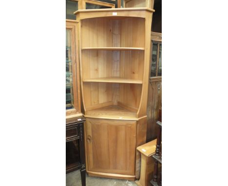 An Ercol light wood corner shelf unit/cabinet, 76cm wide, 179cm high and a small Ercol-style drop-leaf table, (2).