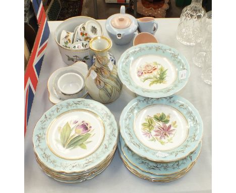 Fourteen pieces of a ceramic dessert set, the blue border transfer-printed with birds and branches and with central floral de