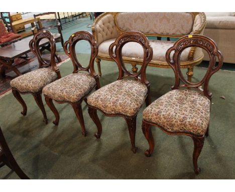Four Victorian balloon back chairs with tapestry seats.