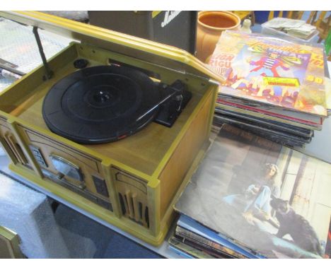 A modern table top record/CD radio player, together with mixed LP records 