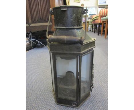 A late 19th/early 20th century oil lamp having a ceramic back 