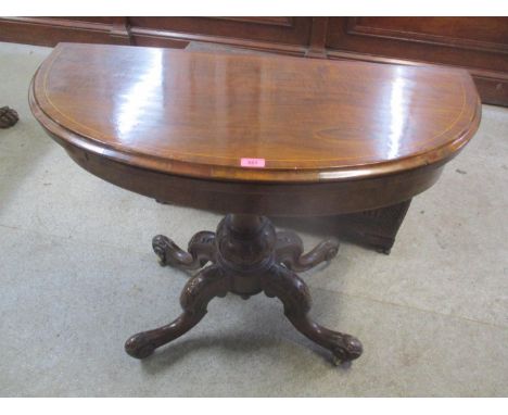 A Victorian walnut fold over card table having string inlaid, bulbous support and four cabriole legs, 29 1/4"h, 39 1/4"w 