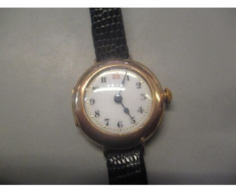 An early 20th century ladies 9ct gold wristwatch having a white enamel dial with Arabic numeralsLocation CAB 