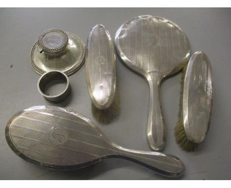 An early 20th century silver machine turned dressing table set, together with a napkin ring and an inkwell 