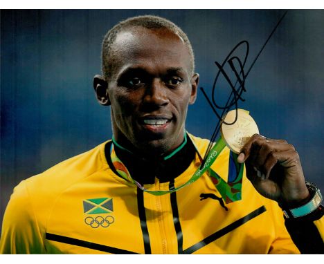 Athletics Legend Usain Bolt Hand signed 10x8 Colour Photo showing bolt proudly showing off his Gold Medal at Rio 2016 Olympic